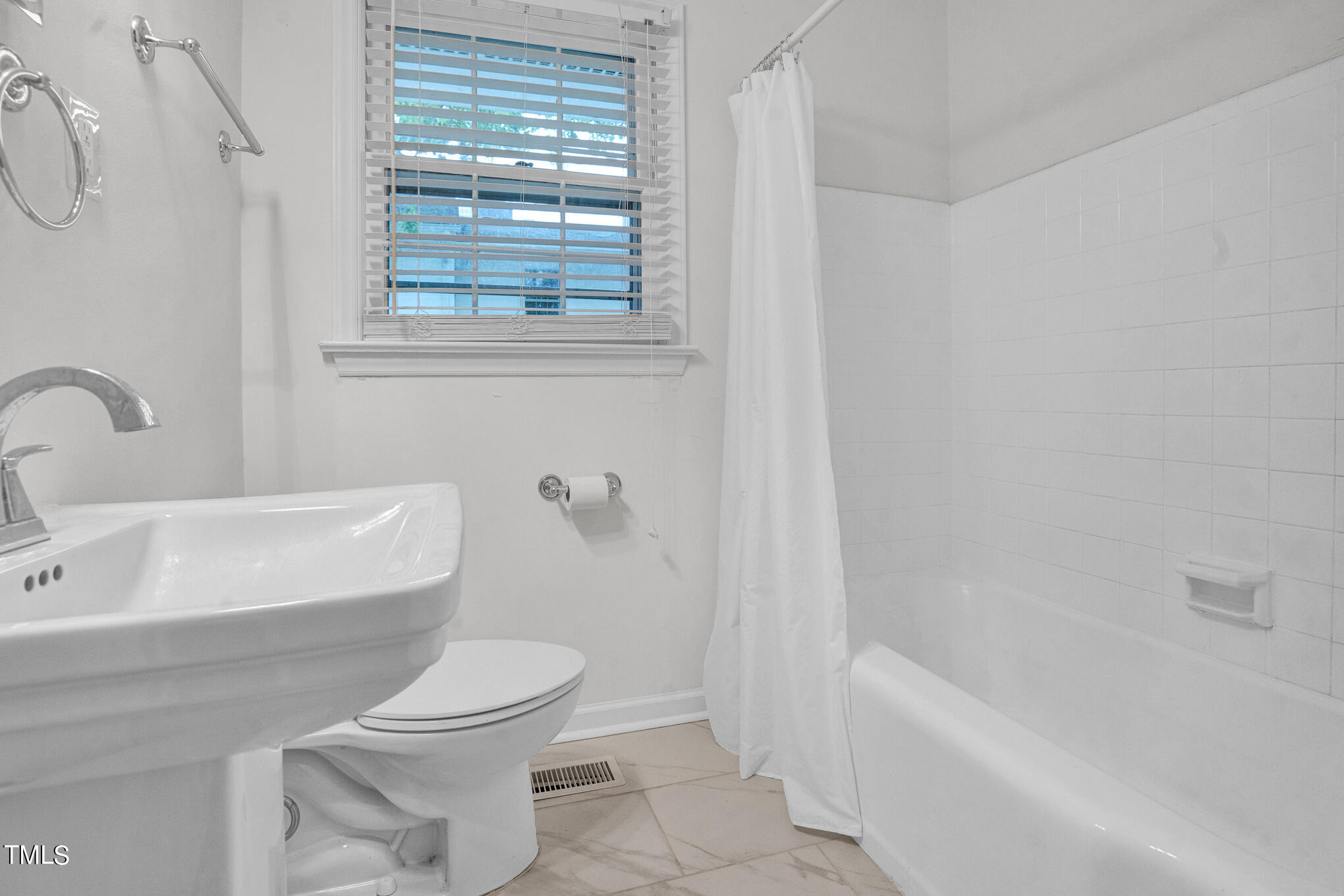 1941 Clark Avenue, Unit 101 Raleigh, NC 27605 - Photo 13 of 15 a bathroom with a toilet a sink and bathtub