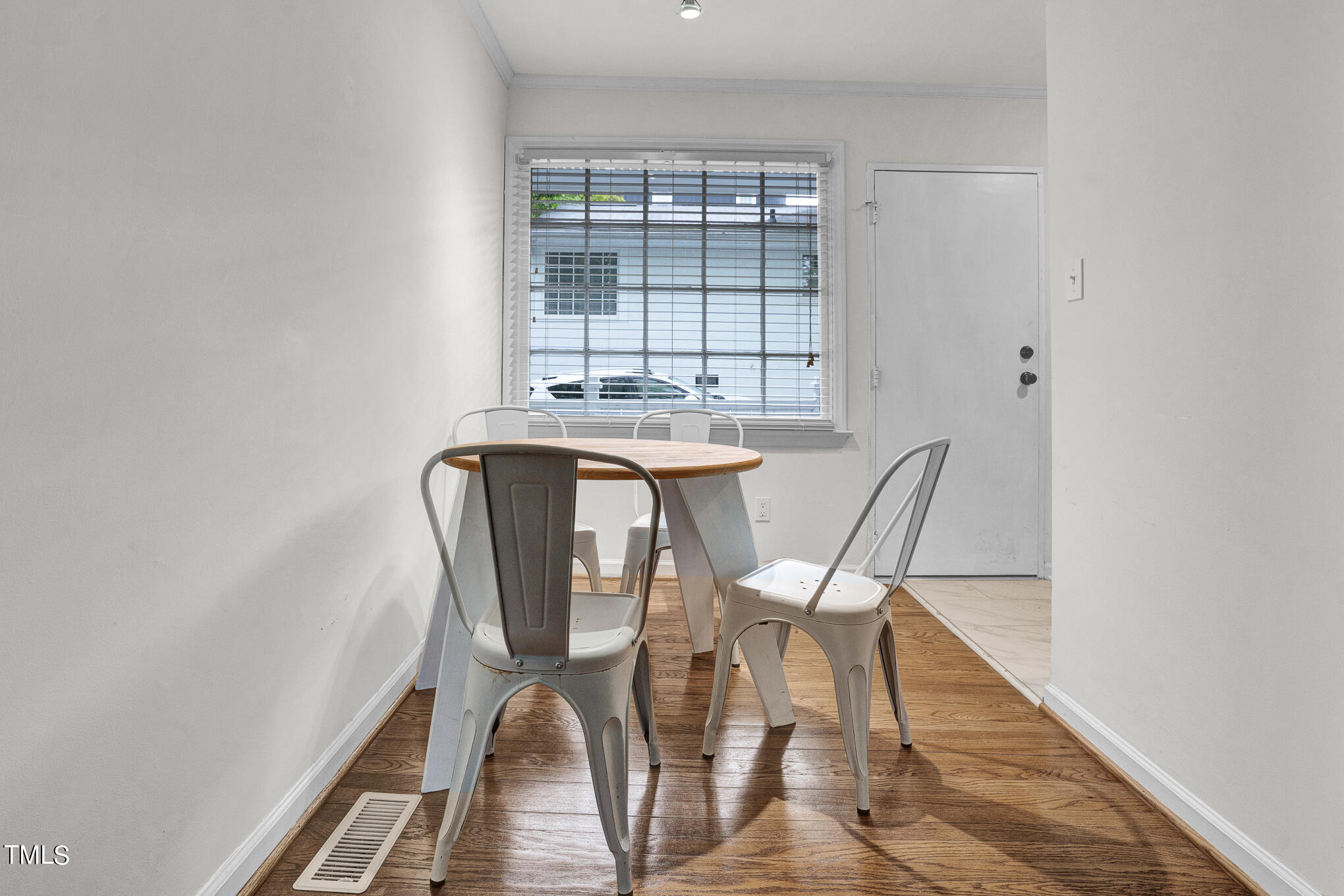 1941 Clark Avenue, Unit 101 Raleigh, NC 27605 - Photo 8 of 15 a view of a dining room with furniture and wooden floor