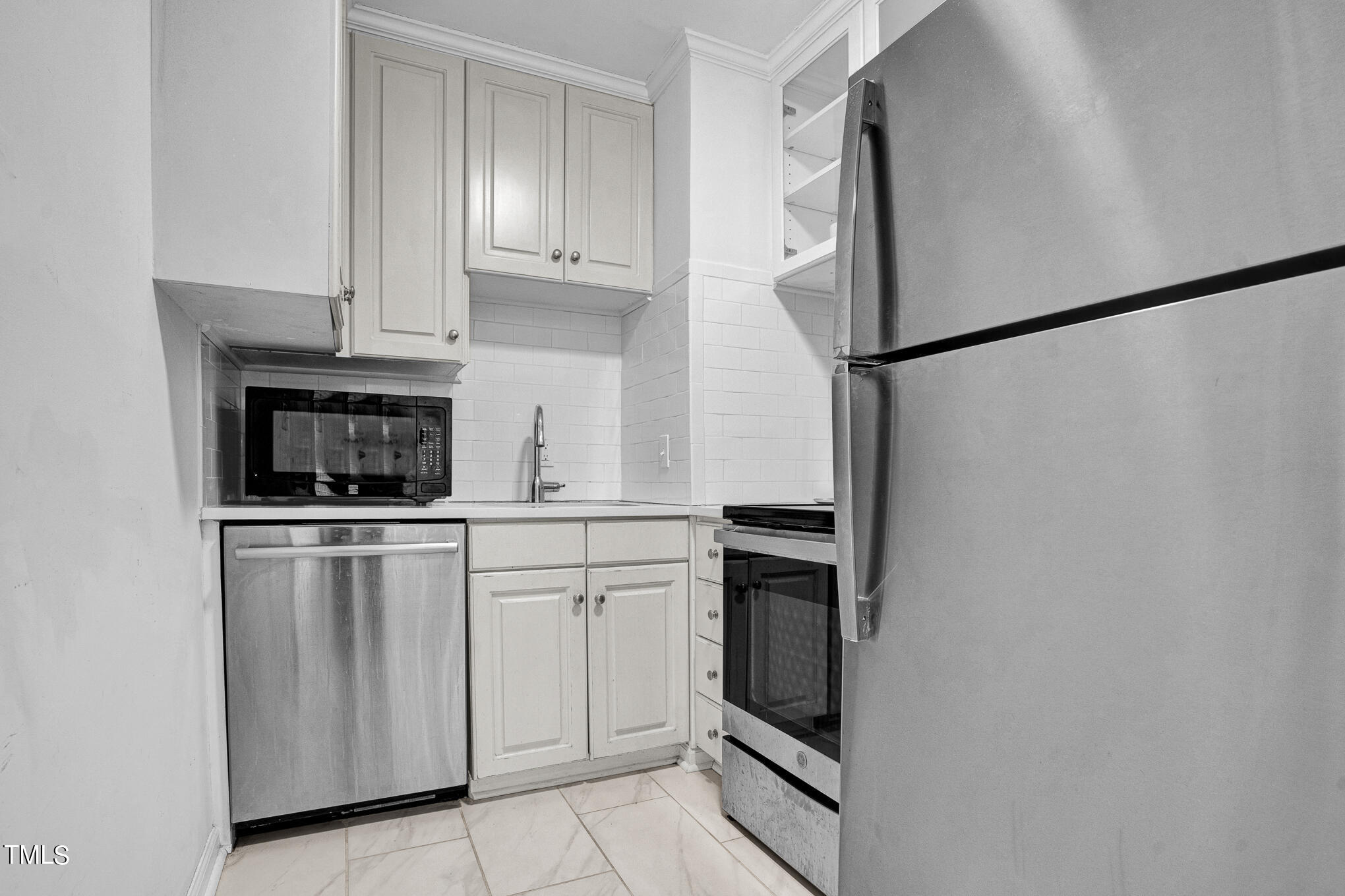 1941 Clark Avenue, Unit 101 Raleigh, NC 27605 - Photo 9 of 15 a kitchen with white cabinets and white appliances