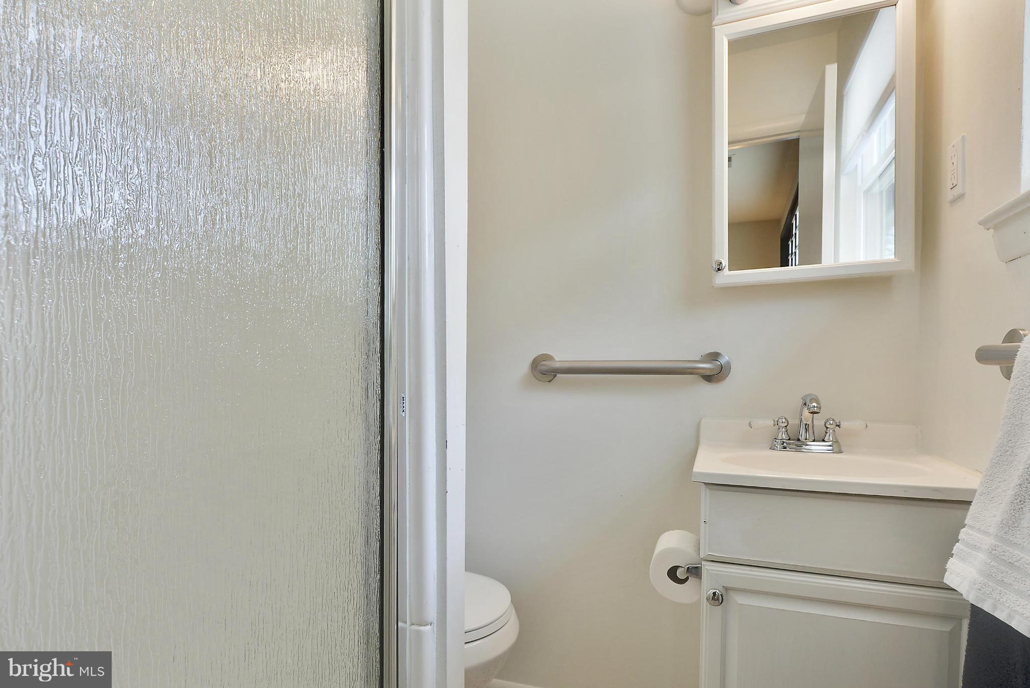 13318 Santa Anita Road Laurel, MD 20708 - Photo 8 of 29 a bathroom with a sink mirror and toilet