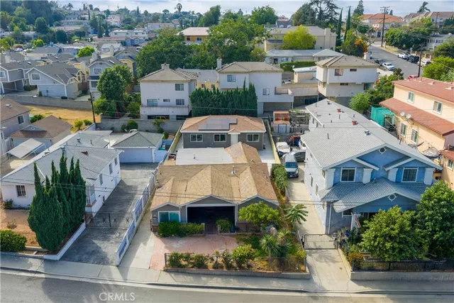 an aerial view of a house with a garden potted plants