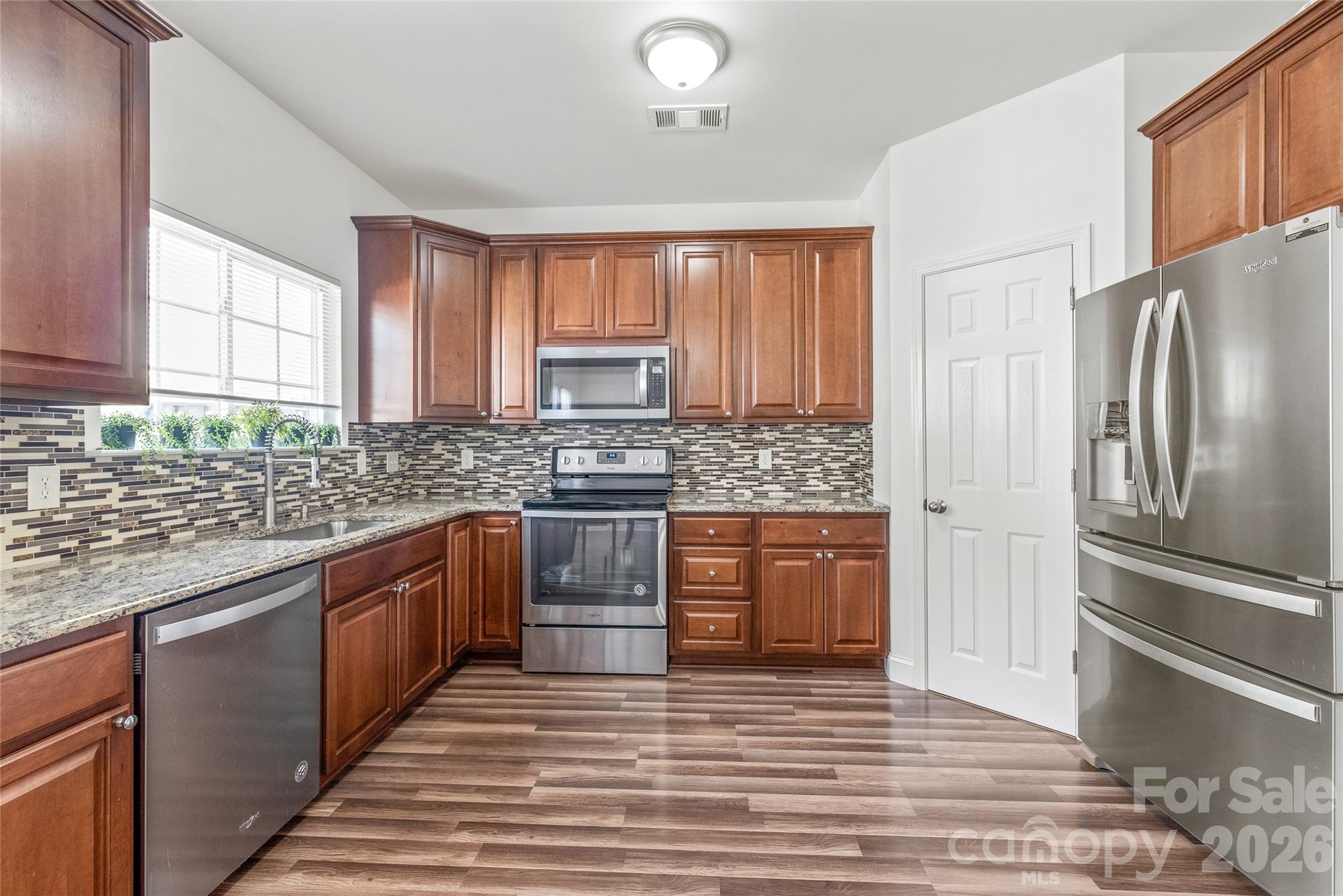 1707 Kashmir White Lane Fort Mill, SC 29708 - Photo 8 of 33 a kitchen with stainless steel appliances granite countertop a refrigerator sink and stove
