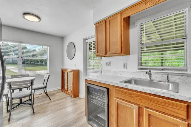 a kitchen with stainless steel appliances granite countertop a sink a stove and wooden floors