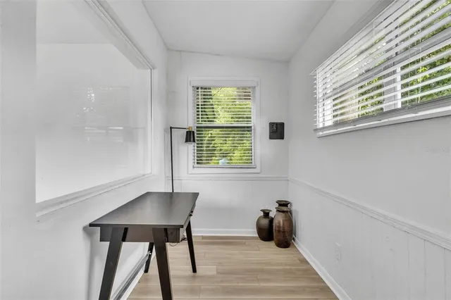 a room with wooden floor and a window