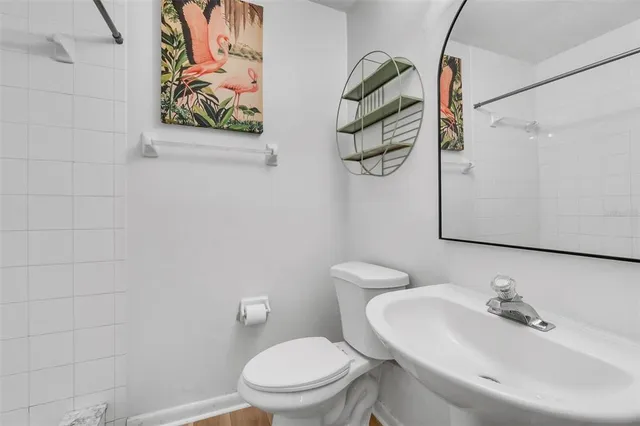 a white toilet sitting next to a bathroom sink