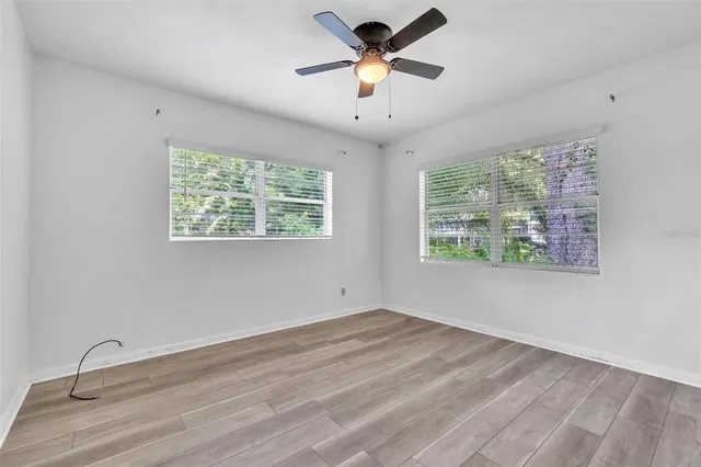 a view of a room with a ceiling fan and a window