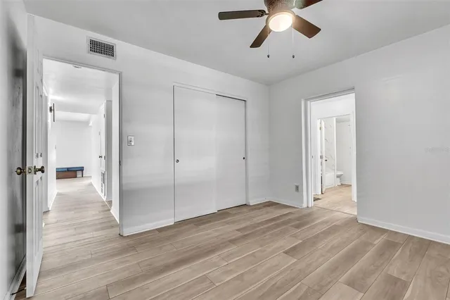 a view of empty room with wooden floor