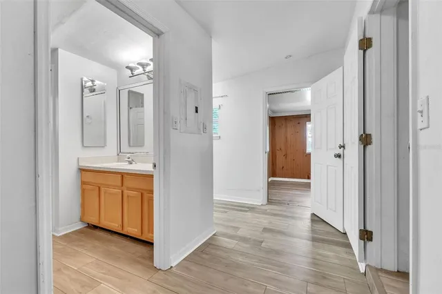 wooden floor with white cabinets