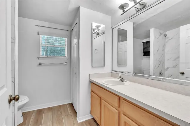 a bathroom with a sink a mirror and shower