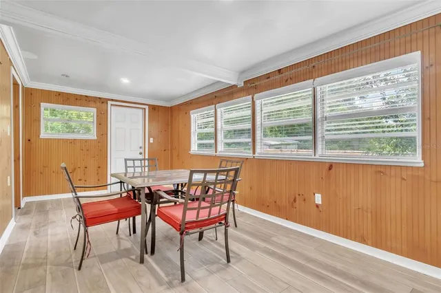 a view of a dining room with furniture and windows