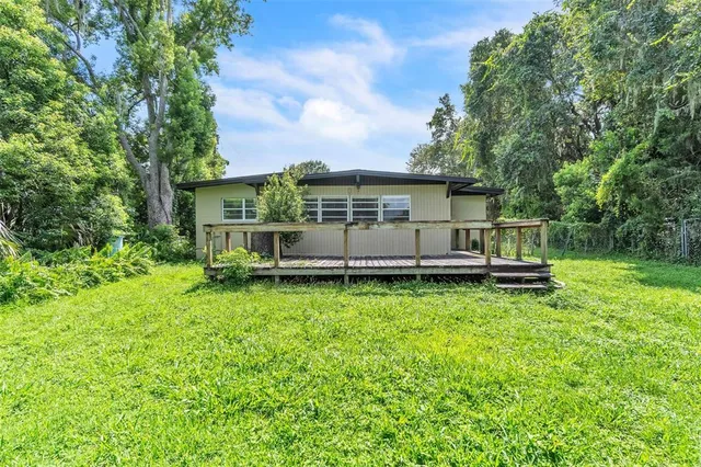 a view of a backyard with a garden and entertaining space