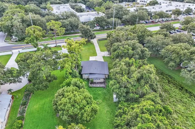 an aerial view of a house with a yard and lake view