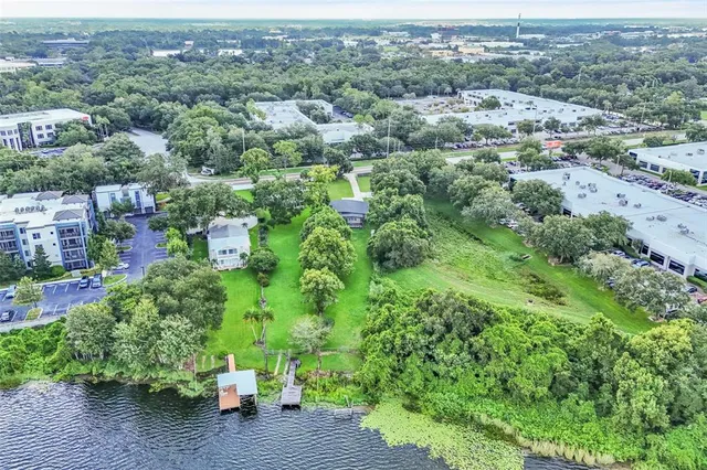 an aerial view of a house with a yard