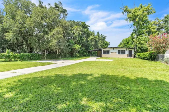 a swimming pool with outdoor seating and yard