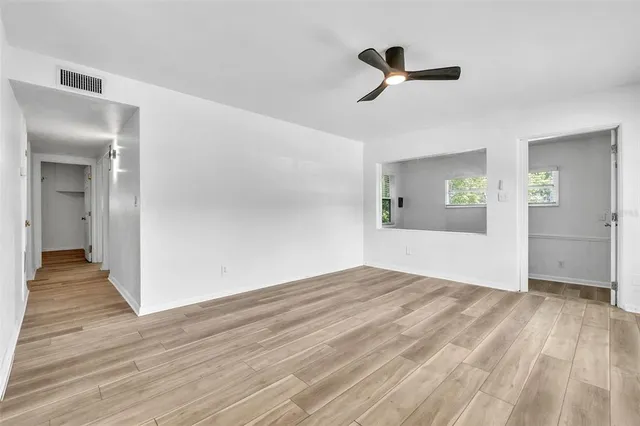 wooden floor in an empty room with a window