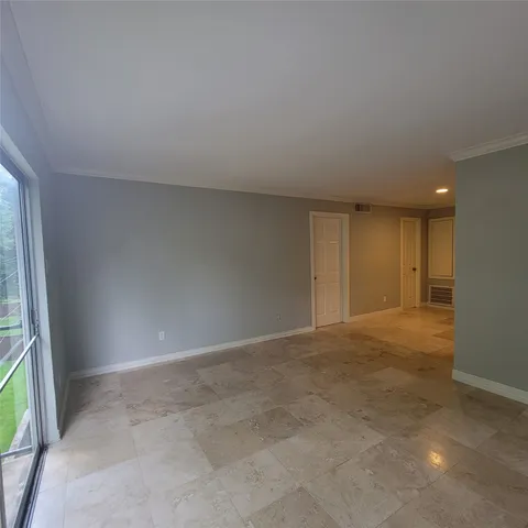 a view of an empty room and a window