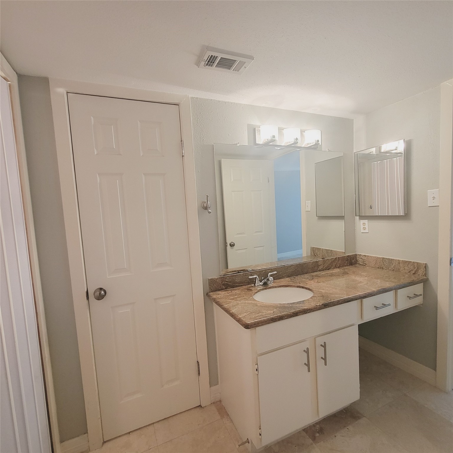 2333 Bering Drive, Unit 226 Houston, TX 77057 - Photo 20 of 33 a bathroom with a granite countertop sink and a mirror