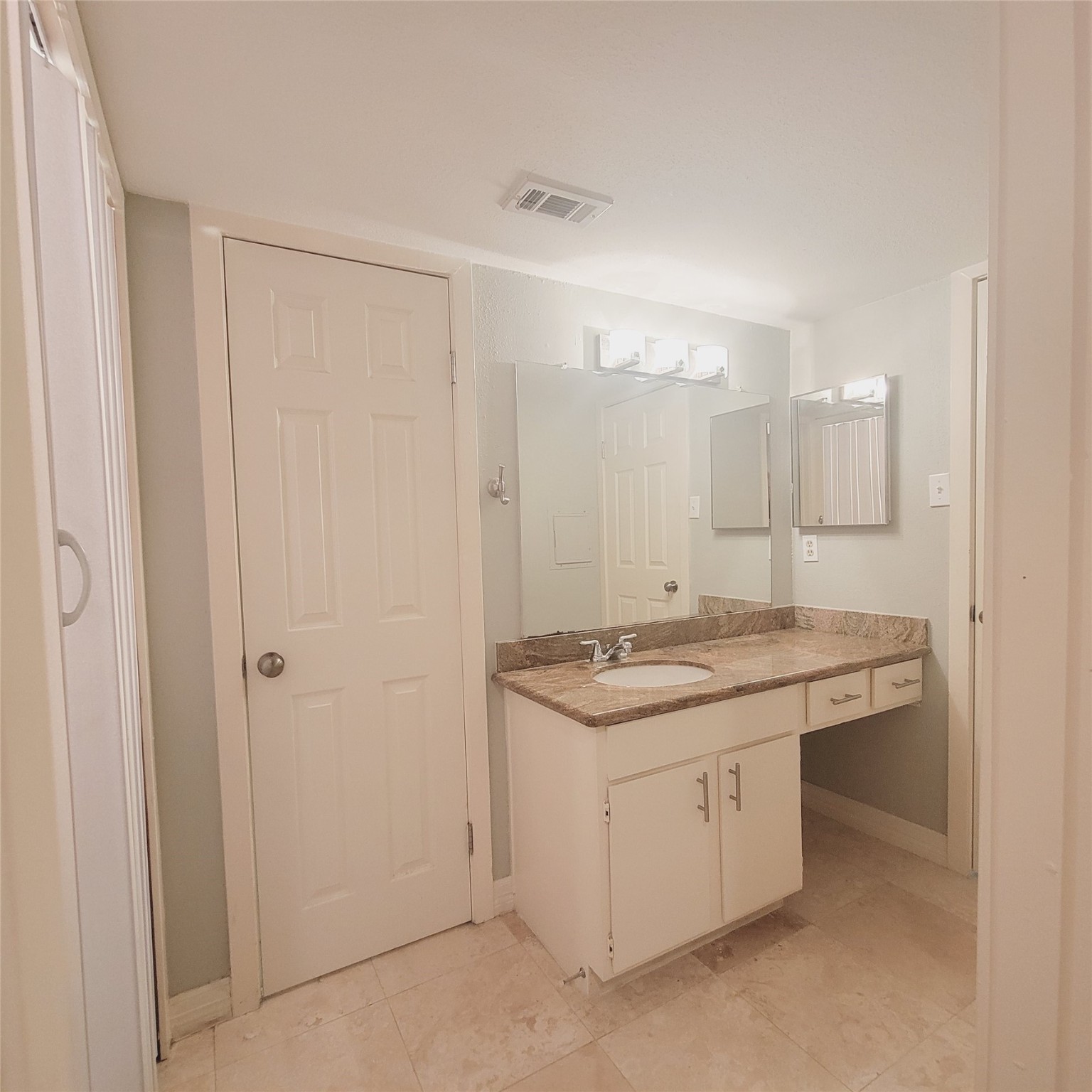 2333 Bering Drive, Unit 226 Houston, TX 77057 - Photo 21 of 33 a bathroom with a granite countertop sink and a mirror