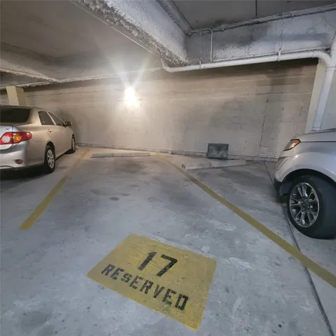 a view of parking garage with cars parked