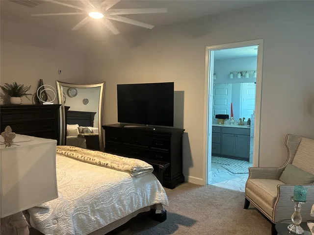 a bedroom with a bed and a television