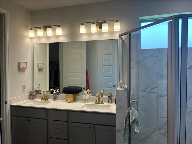 a bathroom with a double vanity sink and a mirror