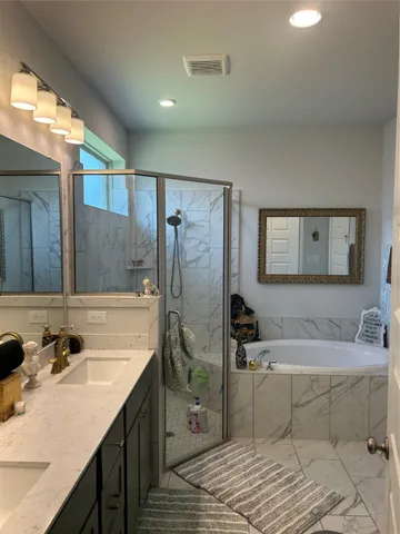 a spacious bathroom with a sink and a mirror