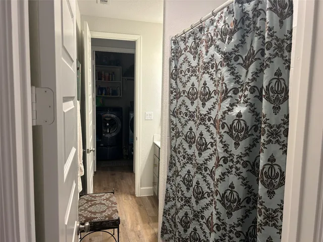a view of a livingroom with wooden floor and a sink