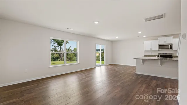 a view of kitchen with windows and wooden floor