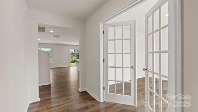 a view of wooden floor and windows in a room