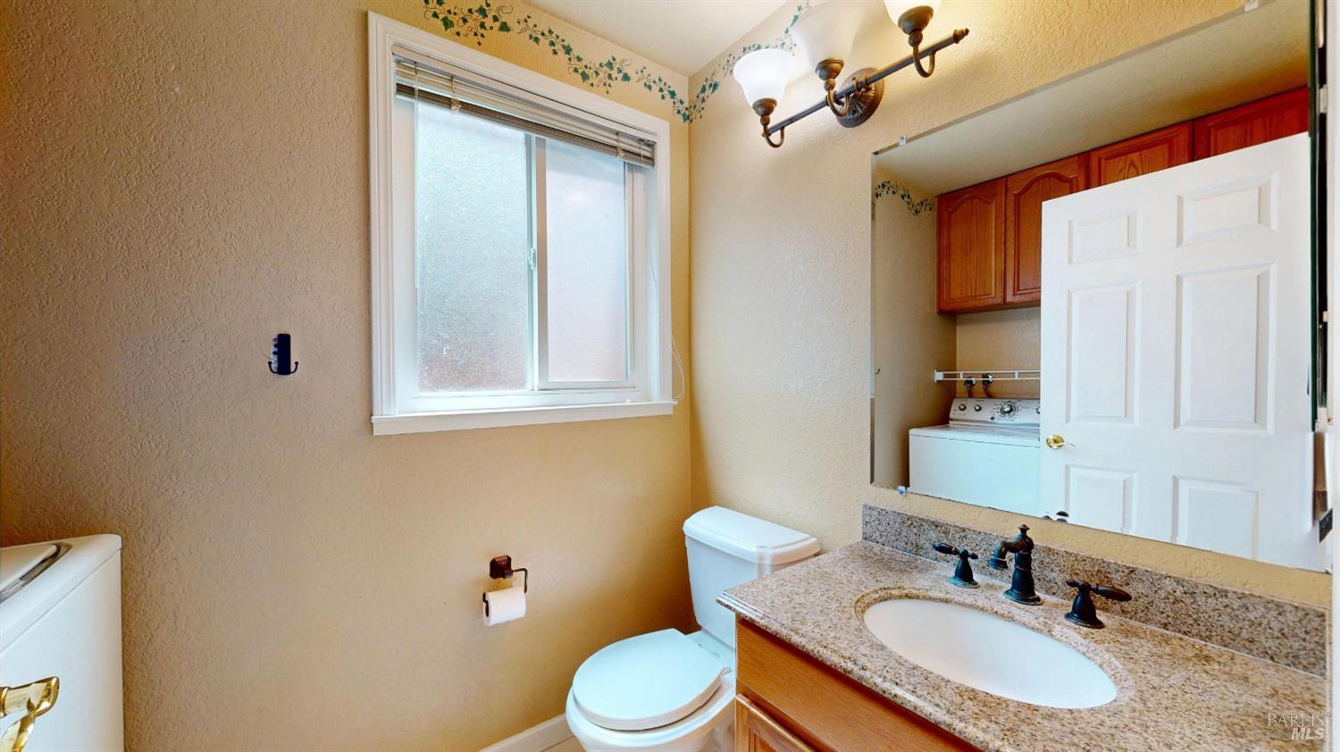 4571 Harbor Lane Rohnert Park, CA 94928 - Photo 24 of 79 a bathroom with a granite countertop sink toilet a mirror and shower