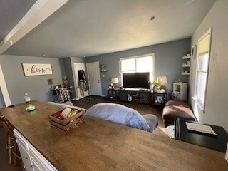 10-12 South Somonauk Road Cortland, IL 60112 - Photo 6 of 29 a bedroom with a bed window and a flat screen tv