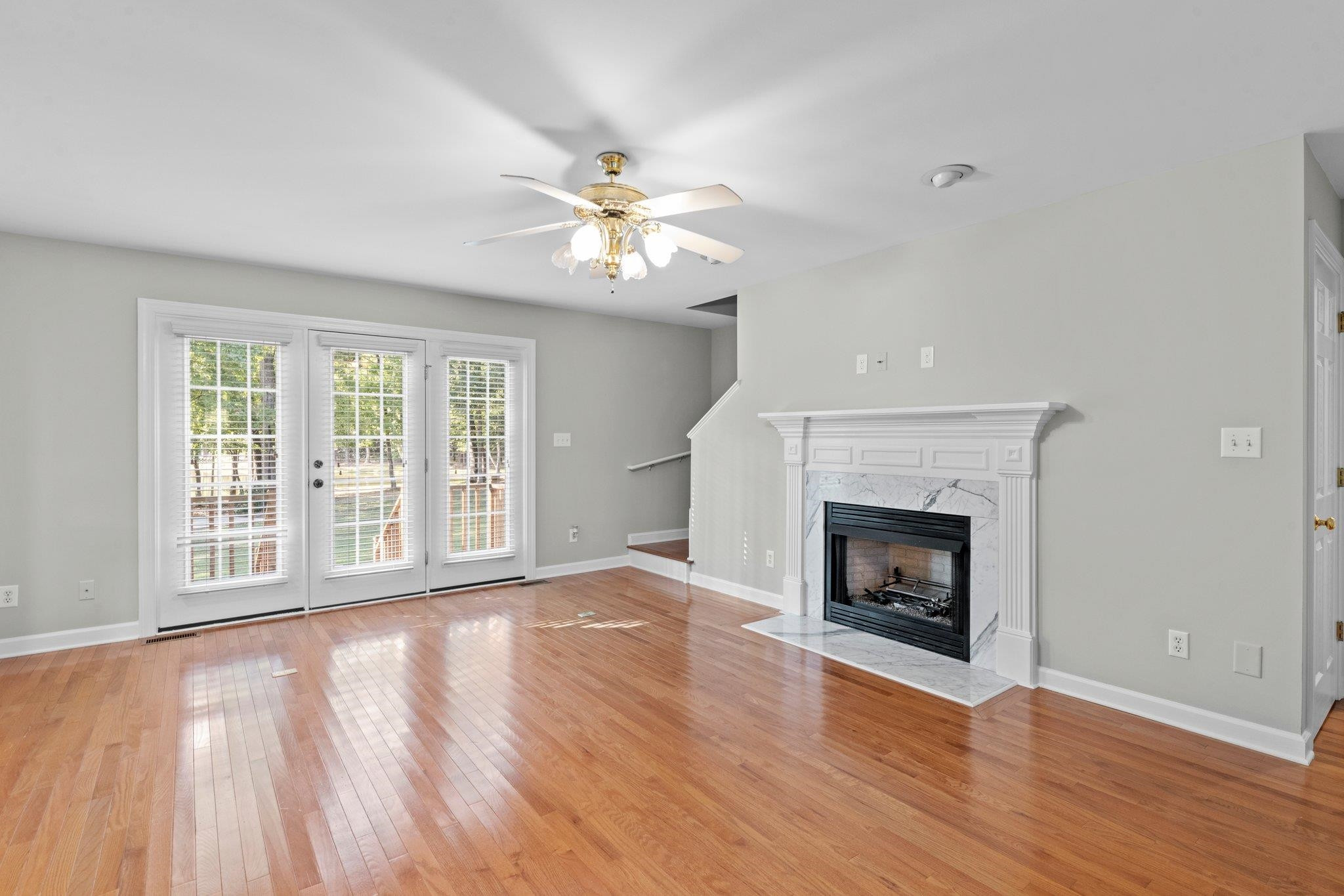 8025 Lockleair Road Zebulon, NC 27597 - Photo 12 of 30 Stairs are tucked behind fireplace wall and convenient to back French doors Stairs to second floor