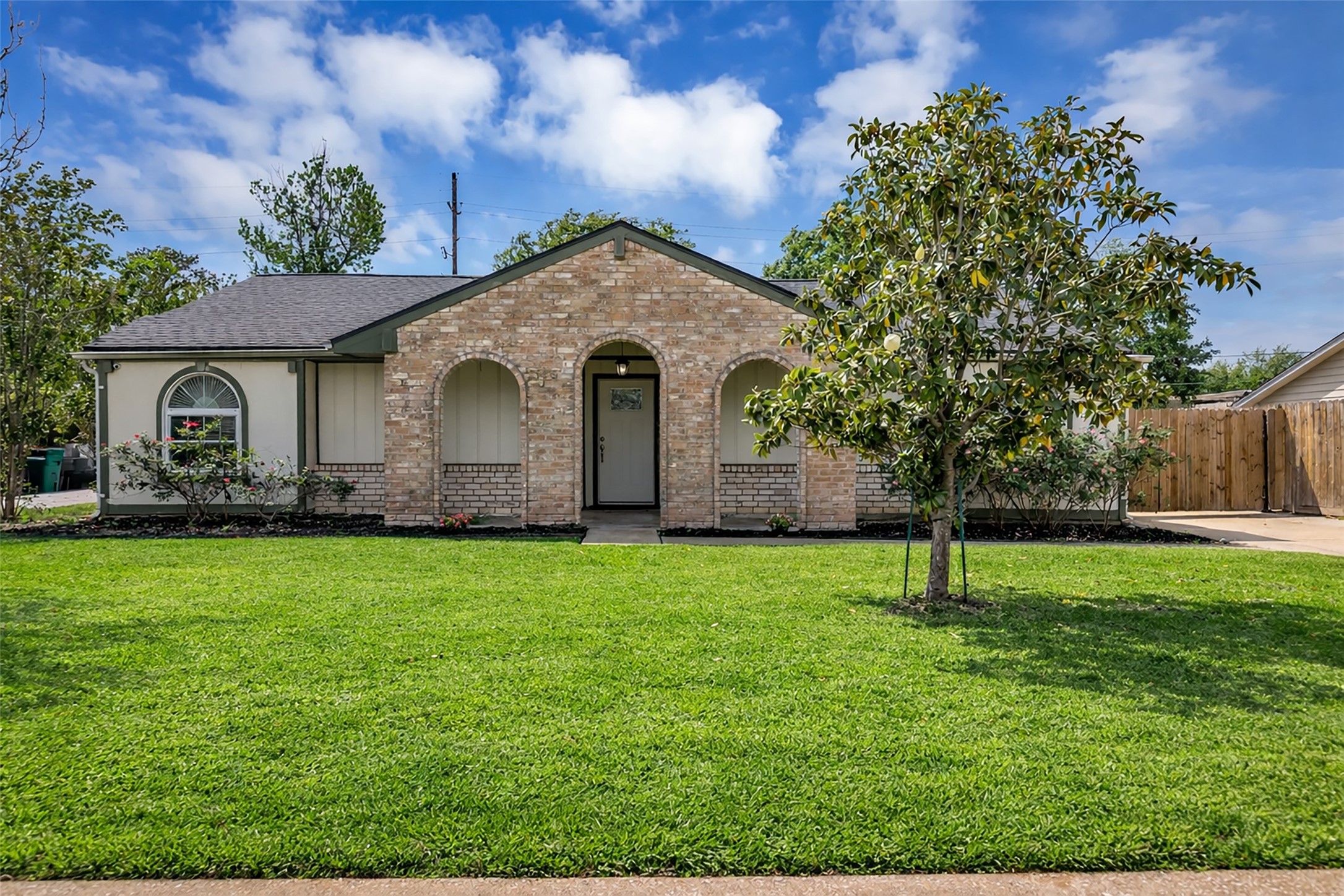 a front view of a house with a garden