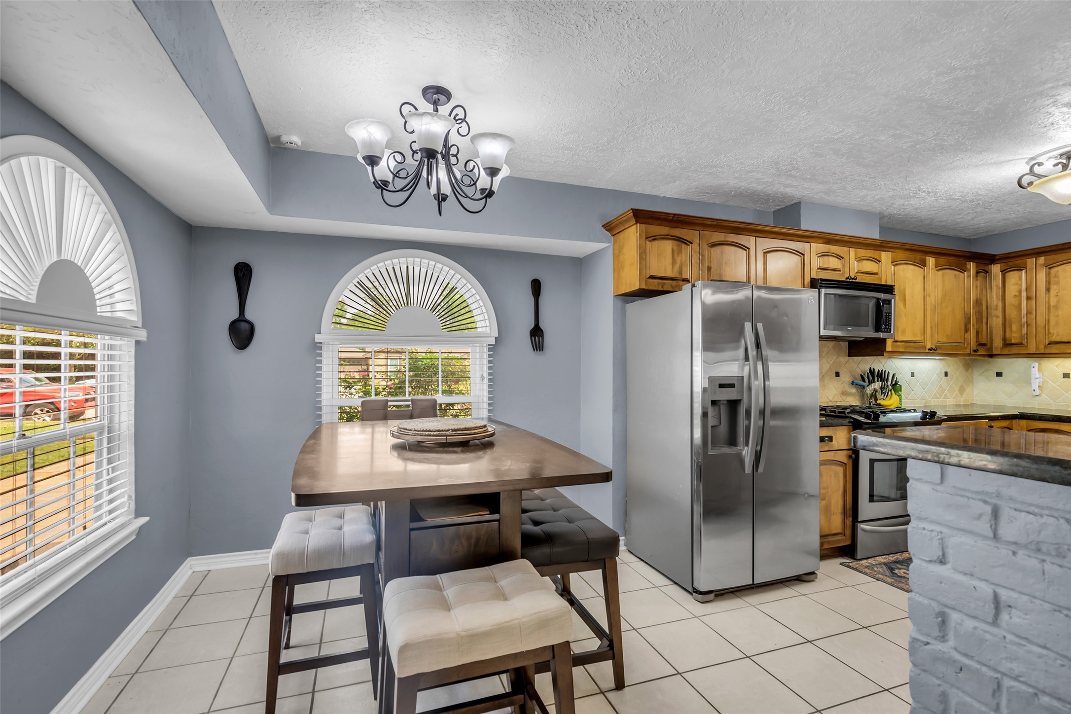 21807 Meadowhill Drive Spring, TX 77388 - Photo 11 of 25 a view of a dining room with furniture a chandelier and wooden floor