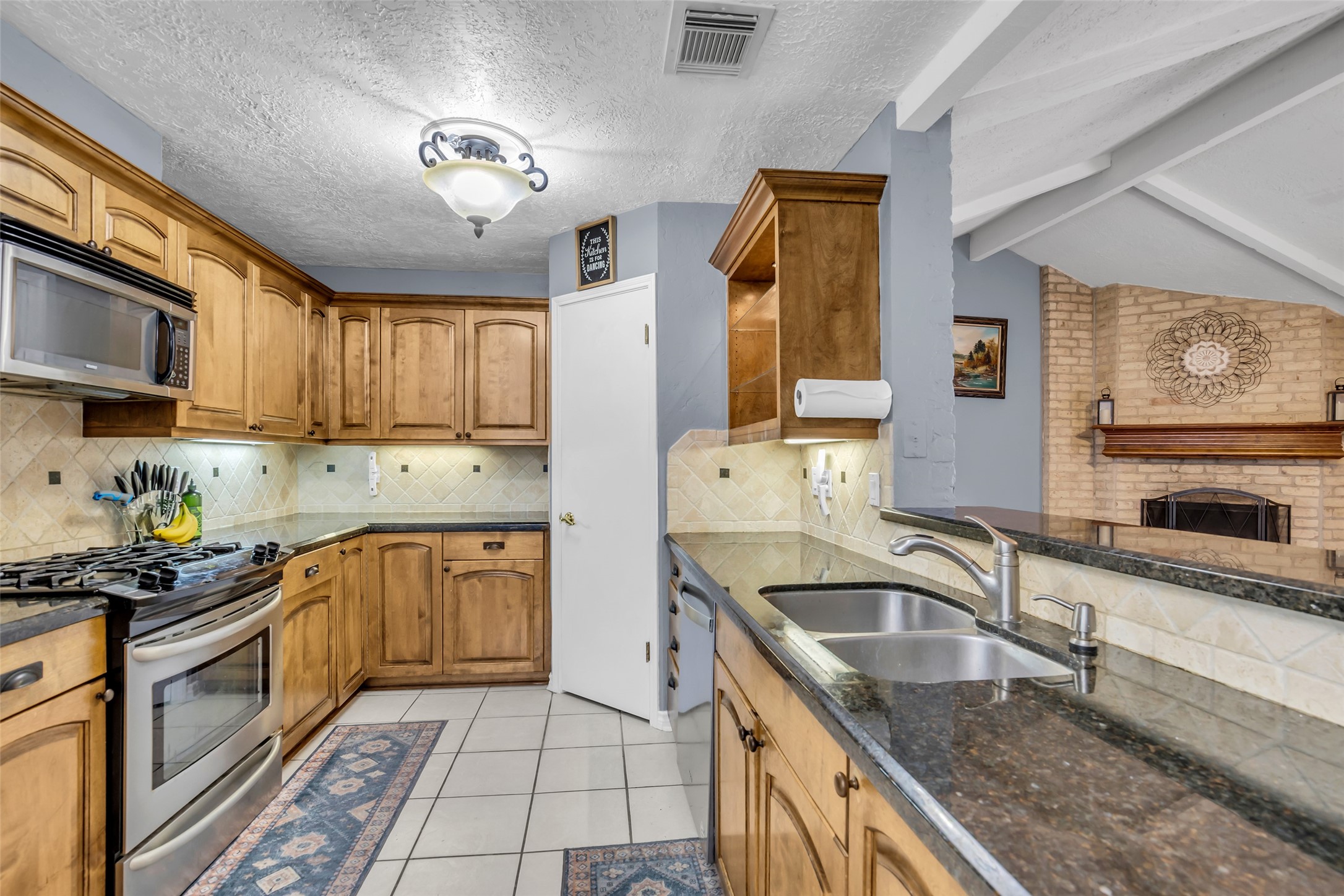 21807 Meadowhill Drive Spring, TX 77388 - Photo 13 of 25 a kitchen with stainless steel appliances granite countertop a sink stove and refrigerator