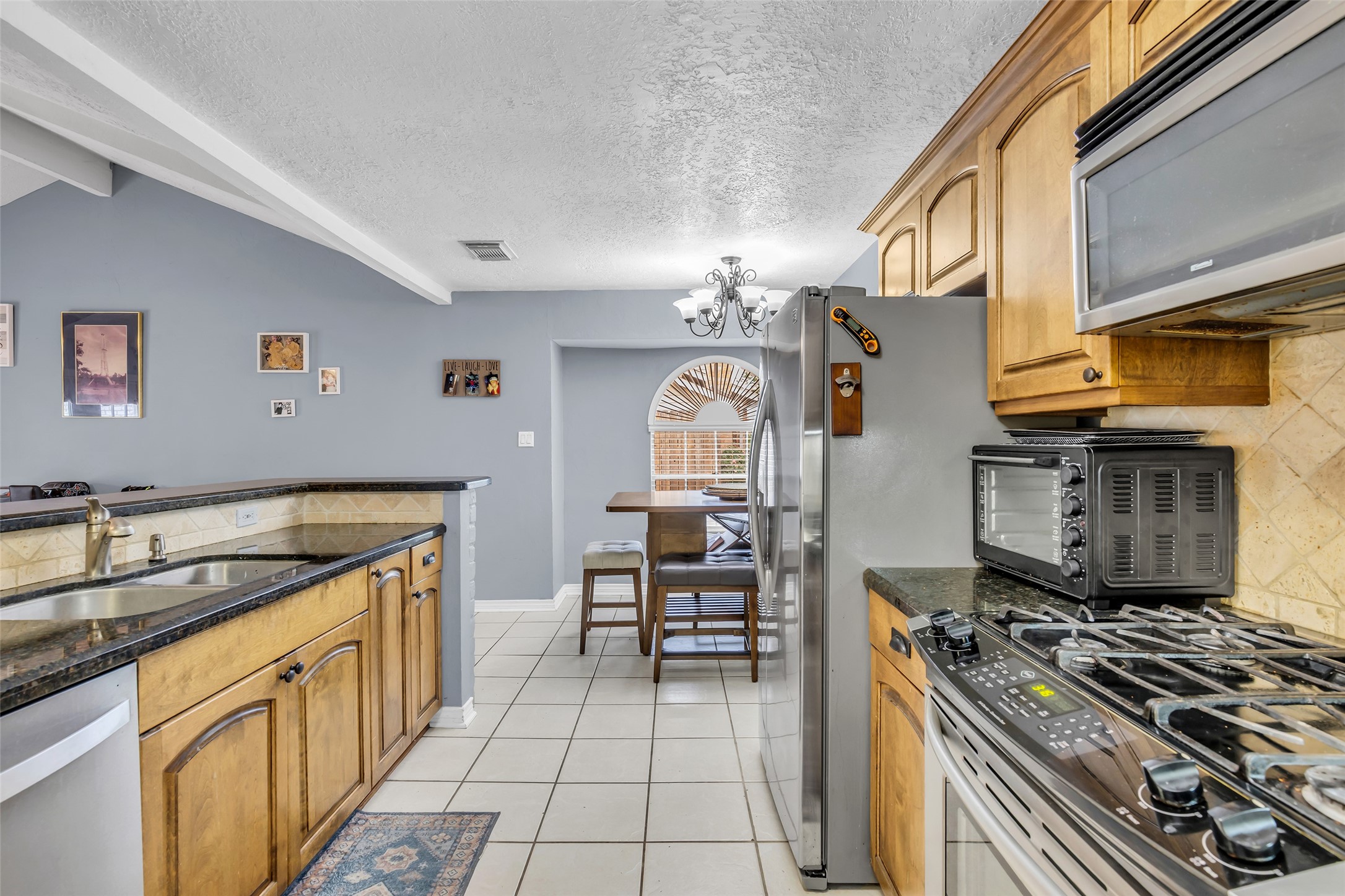 21807 Meadowhill Drive Spring, TX 77388 - Photo 15 of 25 a kitchen with granite countertop a sink stove and cabinets