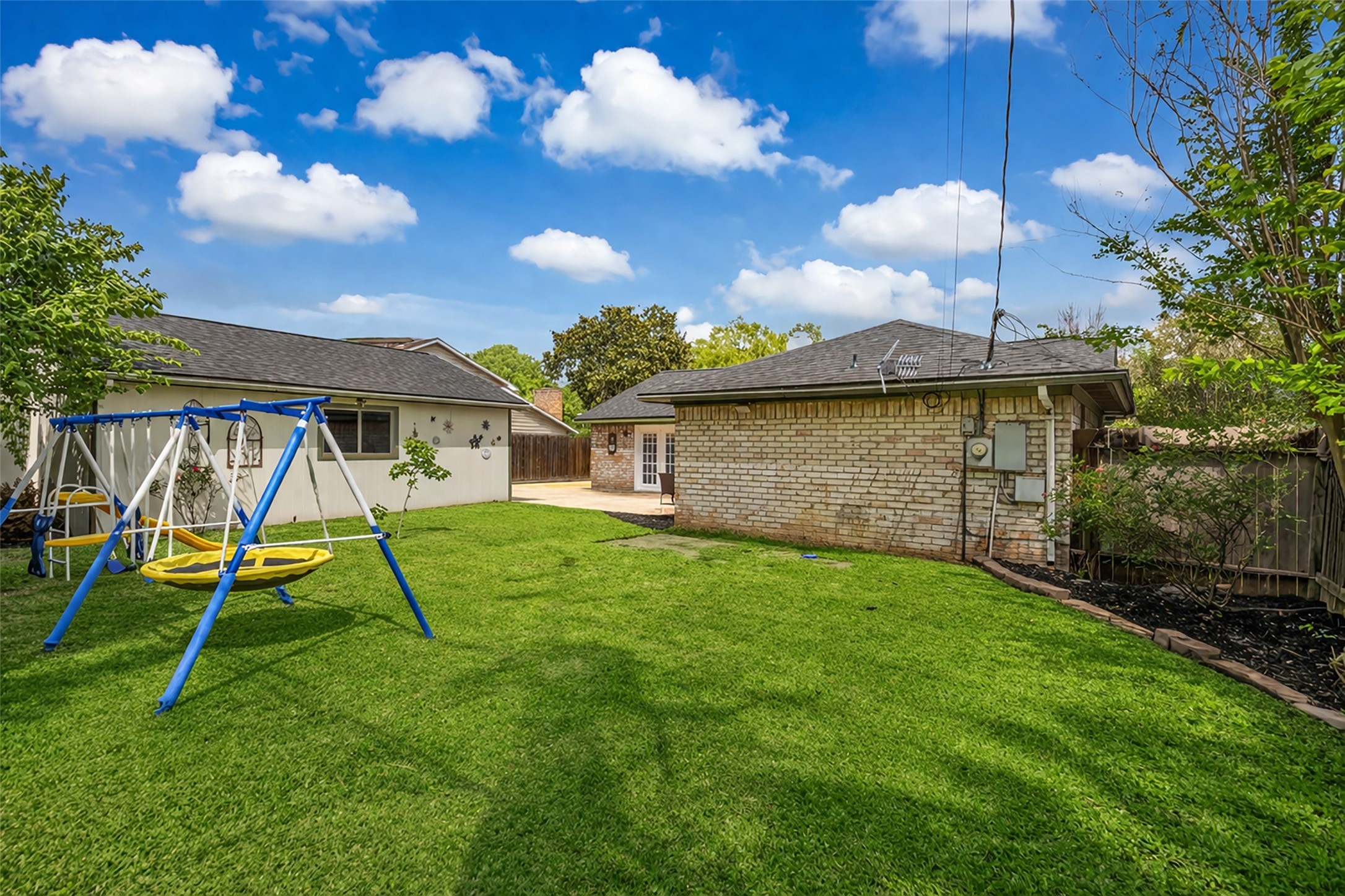 21807 Meadowhill Drive Spring, TX 77388 - Photo 24 of 25 a view of a backyard with a slide and a table