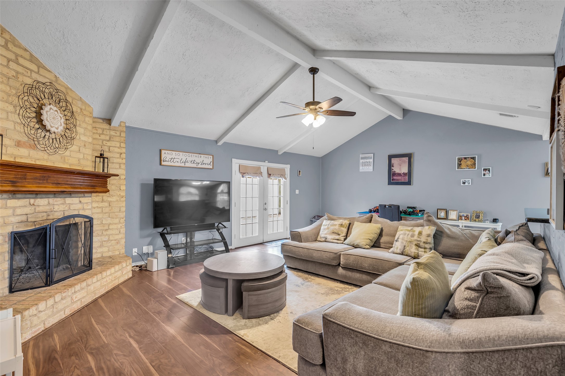 21807 Meadowhill Drive Spring, TX 77388 - Photo 7 of 25 a living room with furniture a fireplace and a flat screen tv