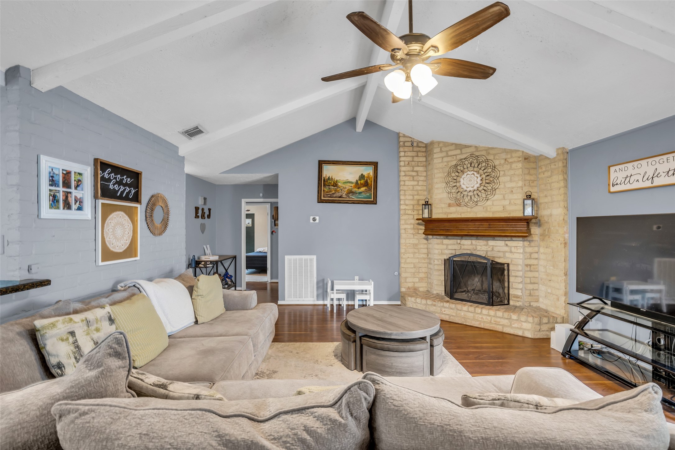 21807 Meadowhill Drive Spring, TX 77388 - Photo 8 of 25 a living room with furniture a fireplace and a flat screen tv