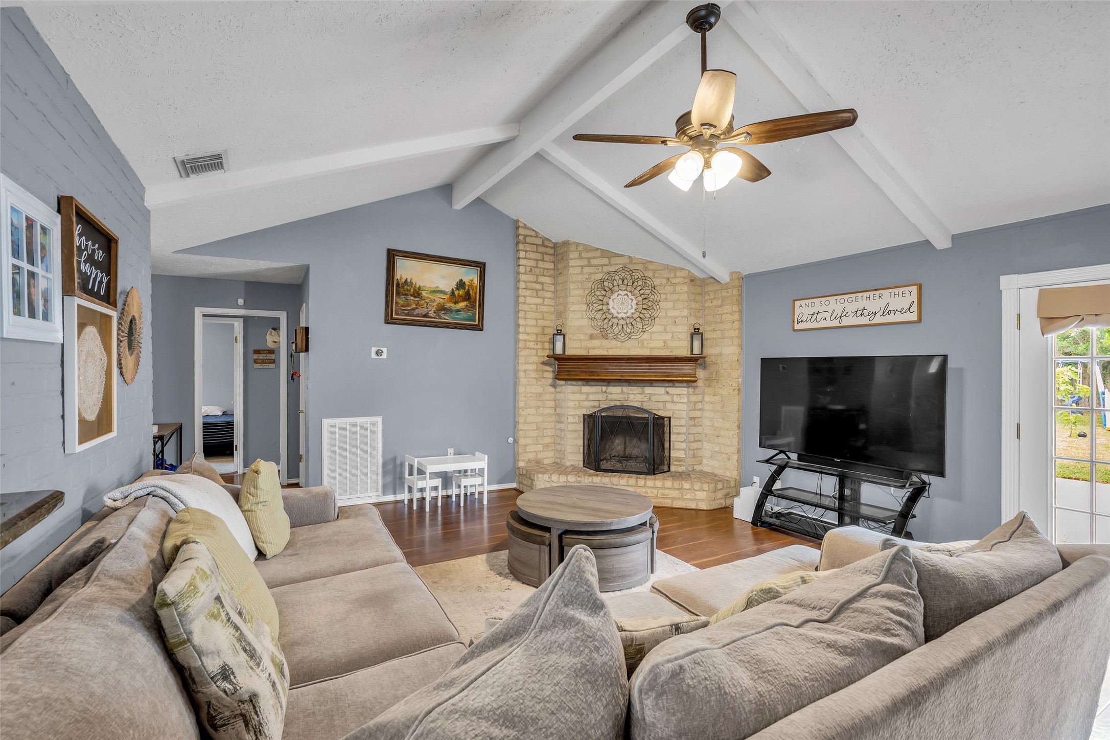 21807 Meadowhill Drive Spring, TX 77388 - Photo 9 of 25 a living room with furniture a flat screen tv and a fireplace