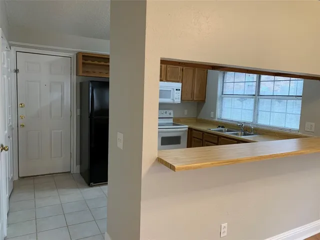 a kitchen that has a sink and a stove