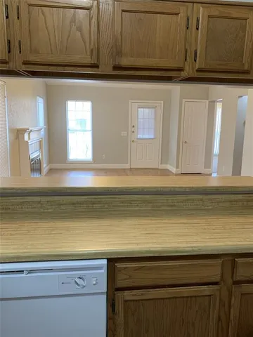 a view of a kitchen with microwave and cabinets