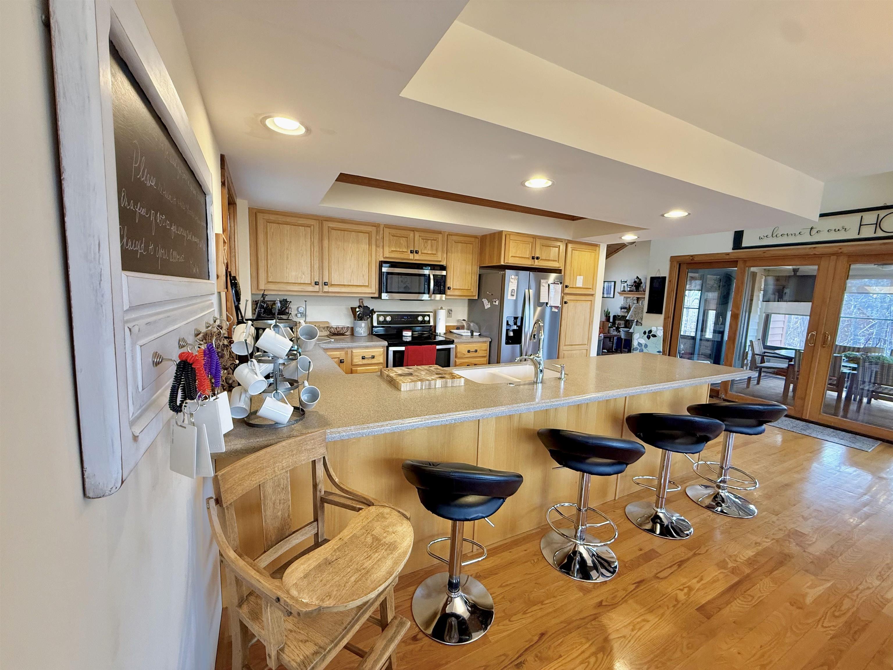 1 Tamarack Row Elizabeth, IL 61028 - Photo 12 of 38 a kitchen with stainless steel appliances kitchen island granite countertop a refrigerator and a dining table