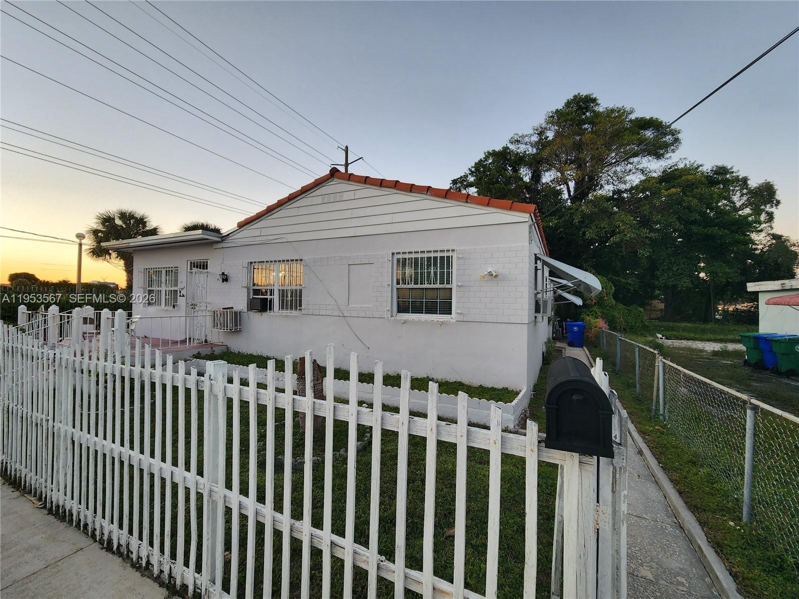 a front view of a house with a garden