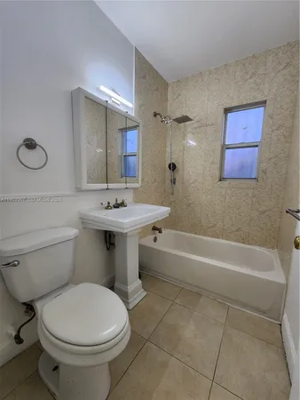 a bathroom with a sink toilet and bathtub