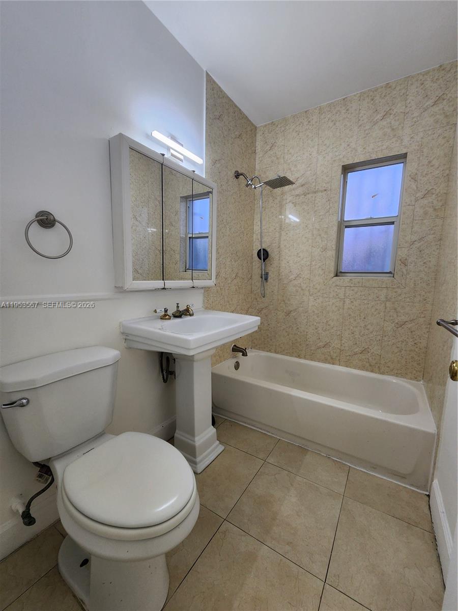 405 Northwest 64th Street, Unit 2 Miami, FL 33150 - Photo 12 of 13 a bathroom with a sink toilet and bathtub