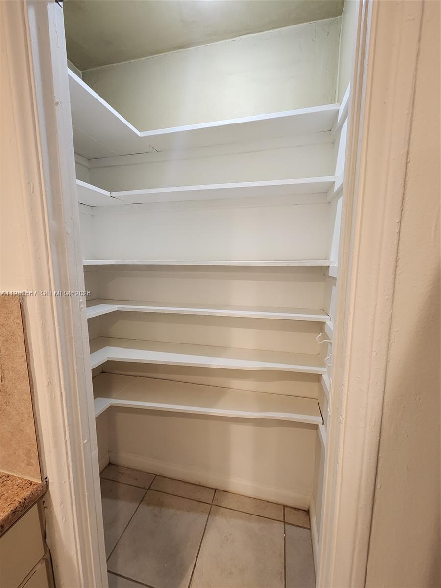 405 Northwest 64th Street, Unit 2 Miami, FL 33150 - Photo 6 of 13 a view of walk in closet with empty racks