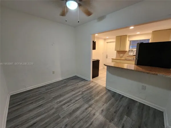 a view of kitchen with wooden floor and electronic appliances