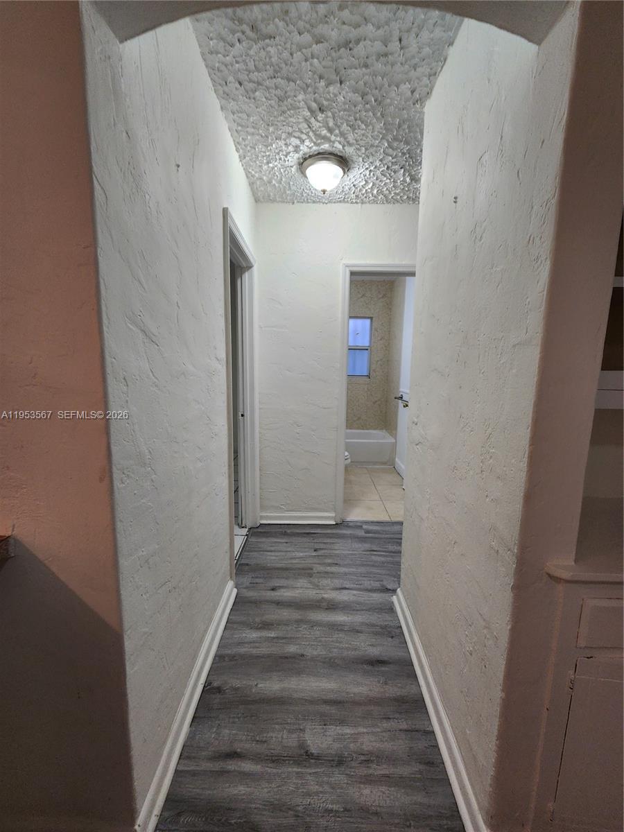405 Northwest 64th Street, Unit 2 Miami, FL 33150 - Photo 9 of 13 a view of a hallway with wooden floor and staircase