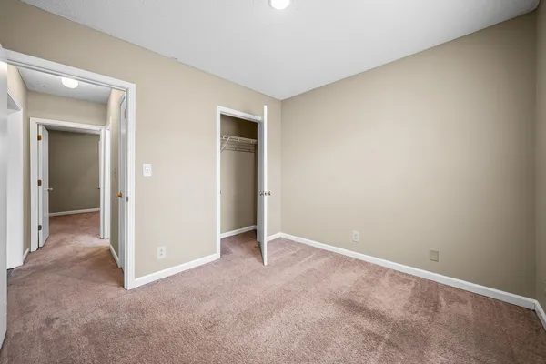a view of an empty room and closet